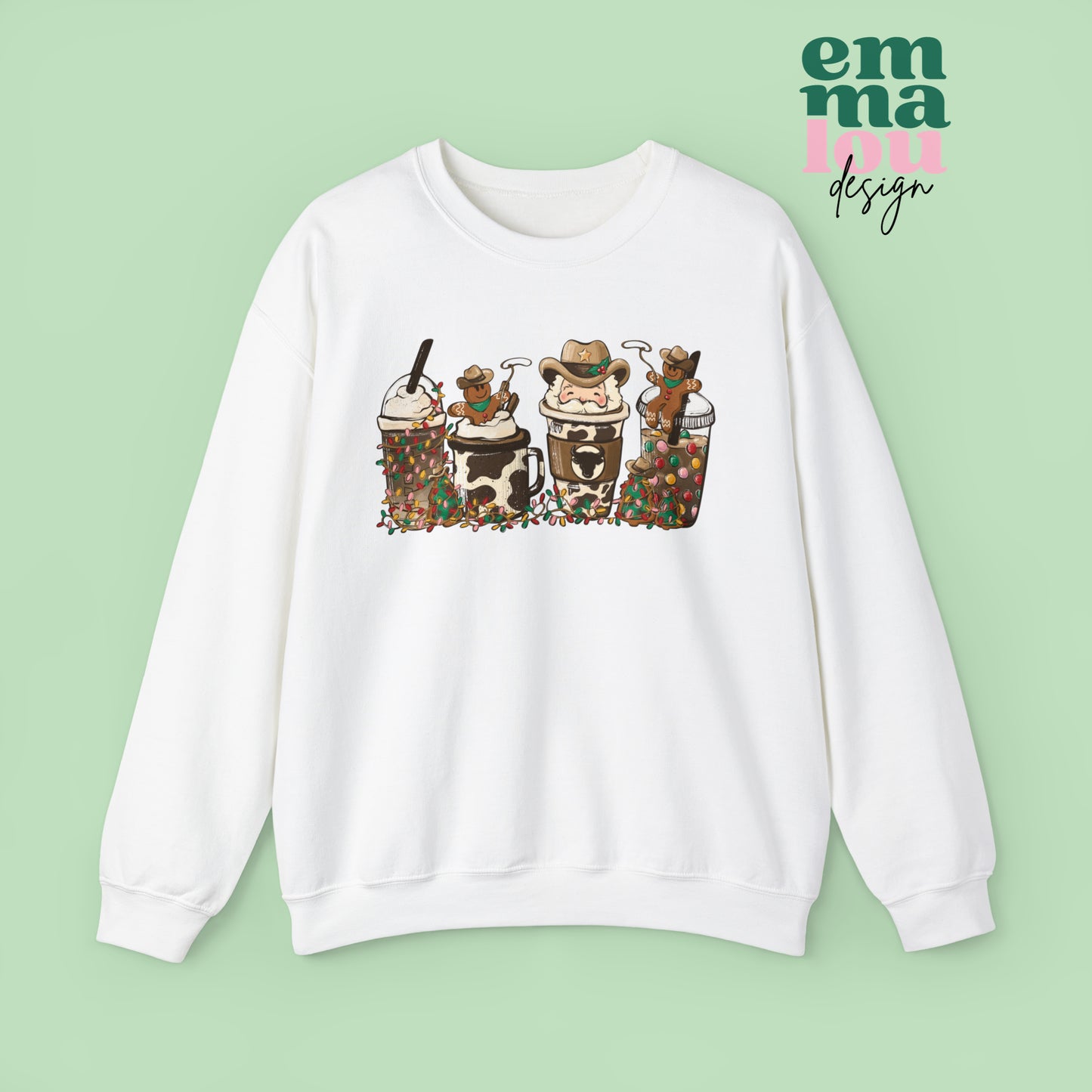 White Sweatshirt featuring four western christmas coffee lattes. The graphic includes two cowboy gingerbread men and a westner Santa Claus with cow print coffee drins and christmas lights.