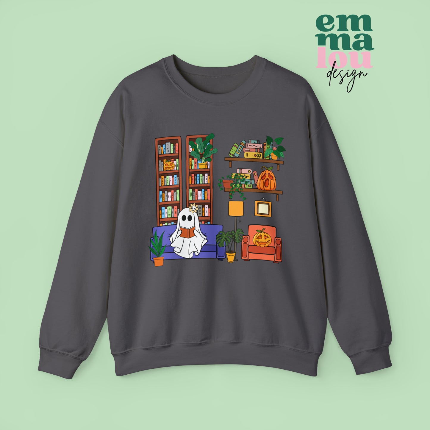 Dark Grey Gildan Crewneck Sweatshirt Featuring a Graphic design featuring a cute ghost with a floral bow reading on a purple couch surrounded by cute house plants and 2 bookcases and shelves with books