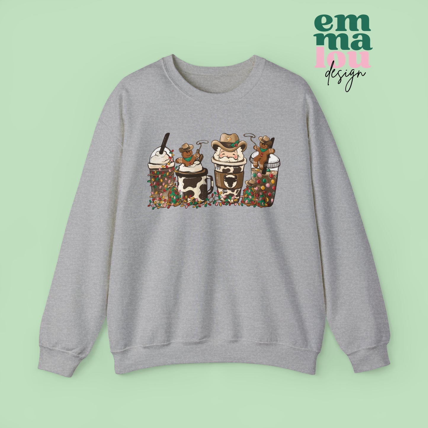 Athletic Grey Sweatshirt featuring four western christmas coffee lattes. The graphic includes two cowboy gingerbread men and a westner Santa Claus with cow print coffee drins and christmas lights.