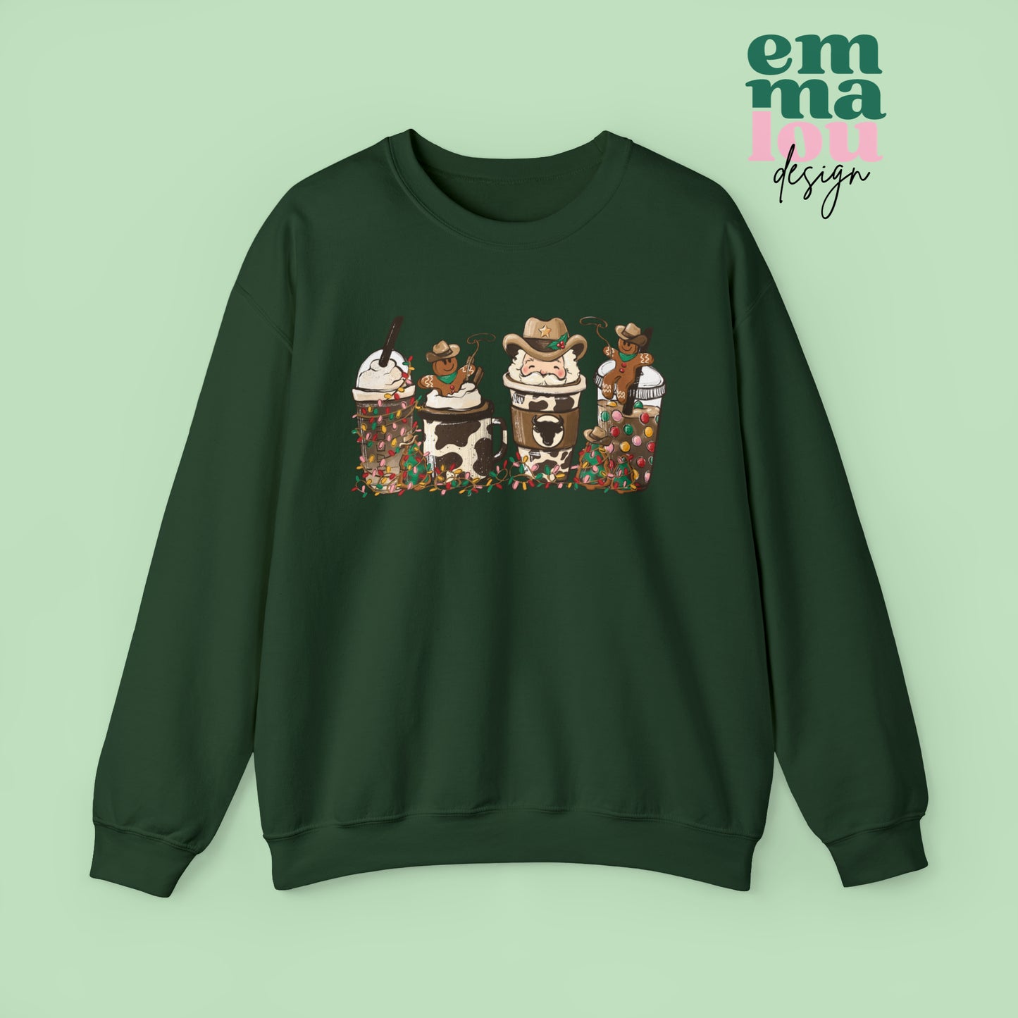 Forest Green Sweatshirt featuring four western christmas coffee lattes. The graphic includes two cowboy gingerbread men and a westner Santa Claus with cow print coffee drins and christmas lights.