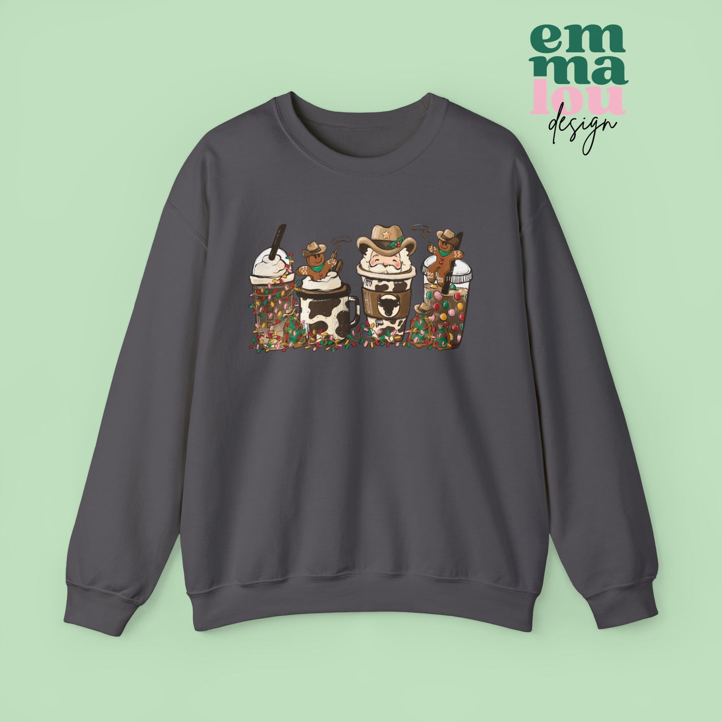 Dark Grey Sweatshirt featuring four western christmas coffee lattes. The graphic includes two cowboy gingerbread men and a westner Santa Claus with cow print coffee drins and christmas lights.