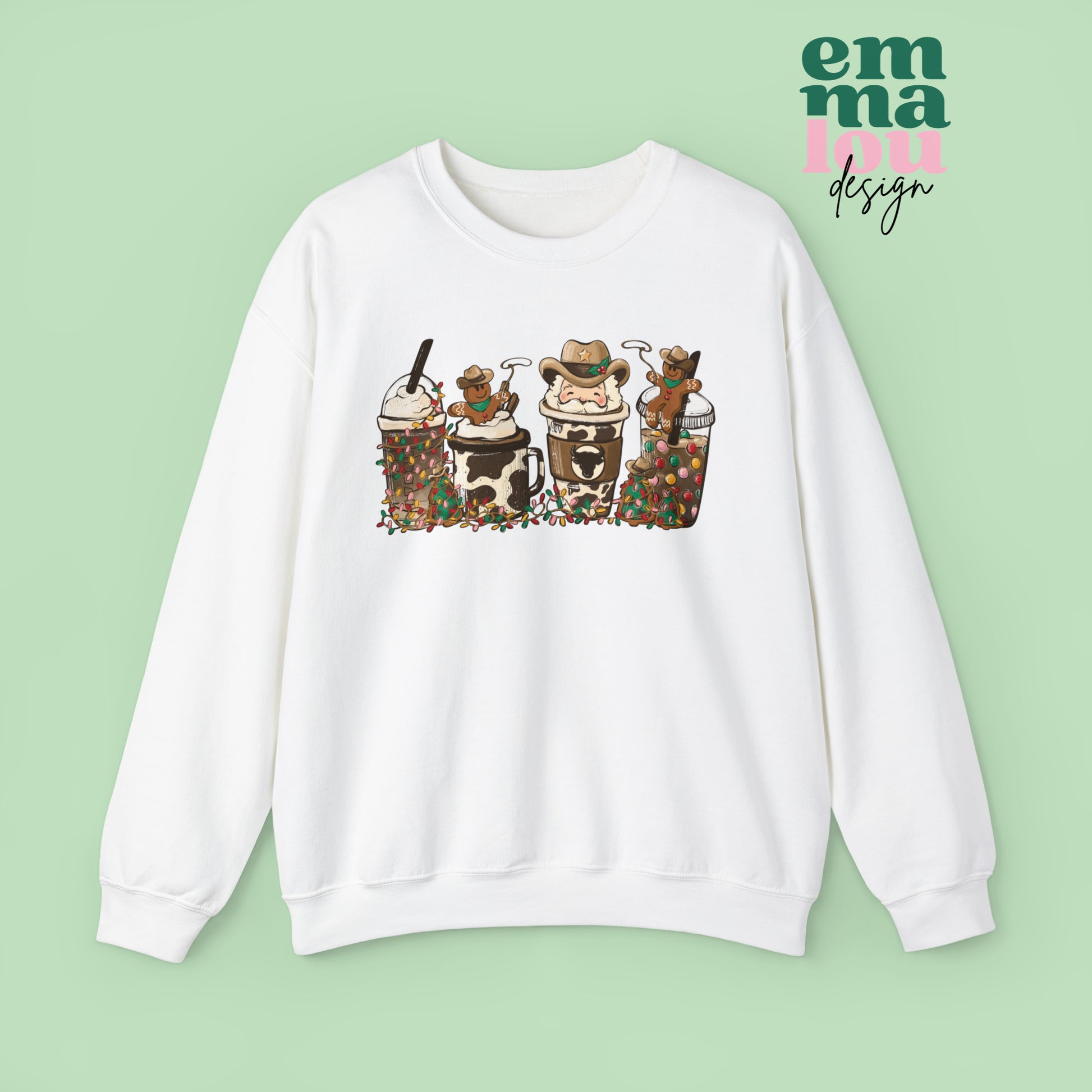 White  Sweatshirt featuring four western christmas coffee lattes. The graphic includes two cowboy gingerbread men and a westner Santa Claus with cow print coffee drins and christmas lights.