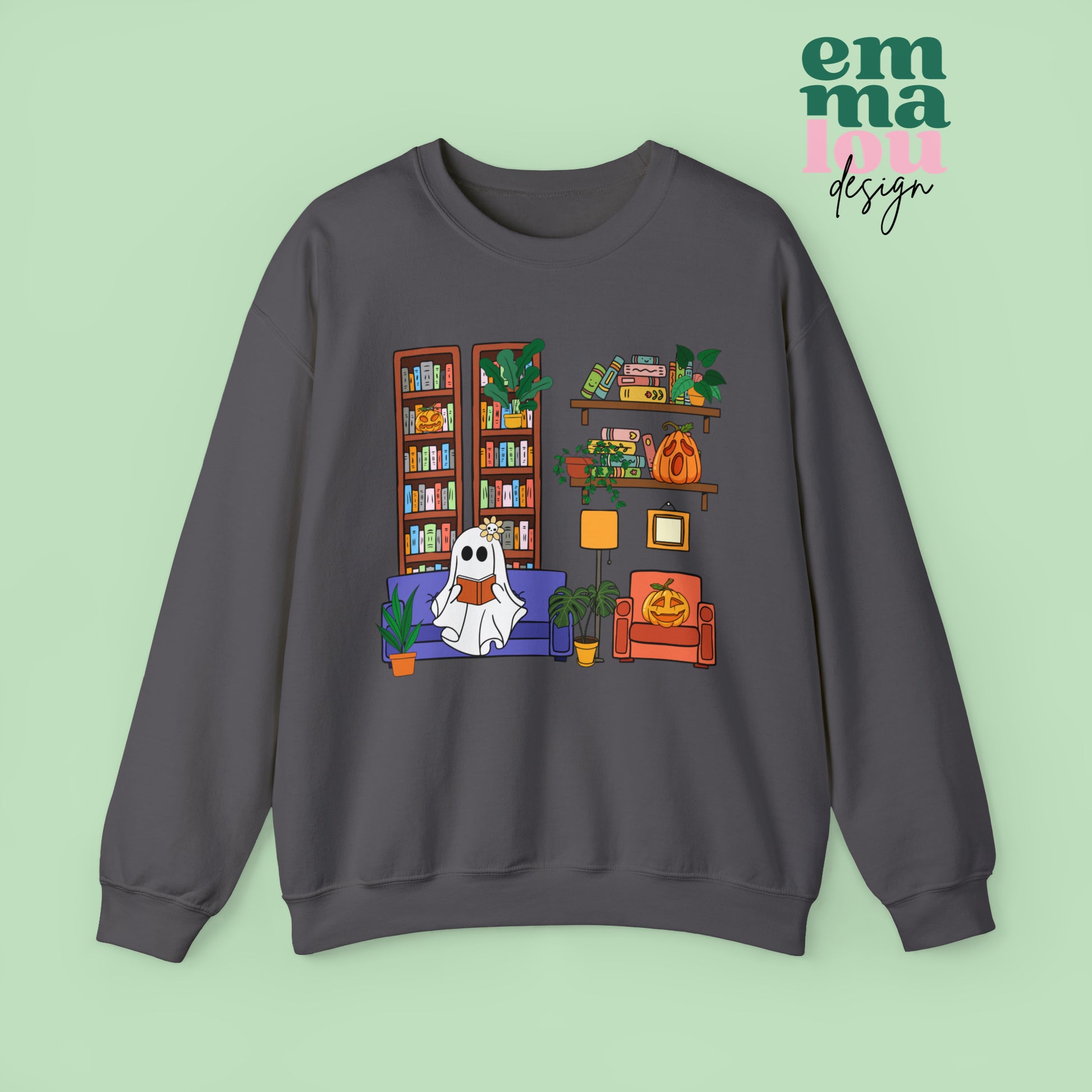 Dark Grey  Gildan Crewneck Sweatshirt Featuring a Graphic design featuring a cute ghost with a floral bow reading on a purple couch surrounded by cute house plants and 2 bookcases and shelves with books