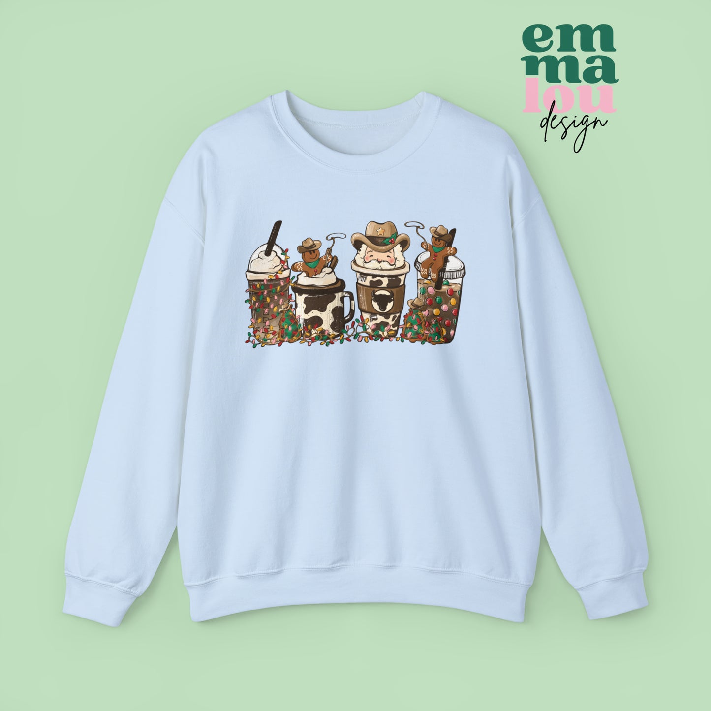 Light Blue  Sweatshirt featuring four western christmas coffee lattes. The graphic includes two cowboy gingerbread men and a westner Santa Claus with cow print coffee drins and christmas lights.