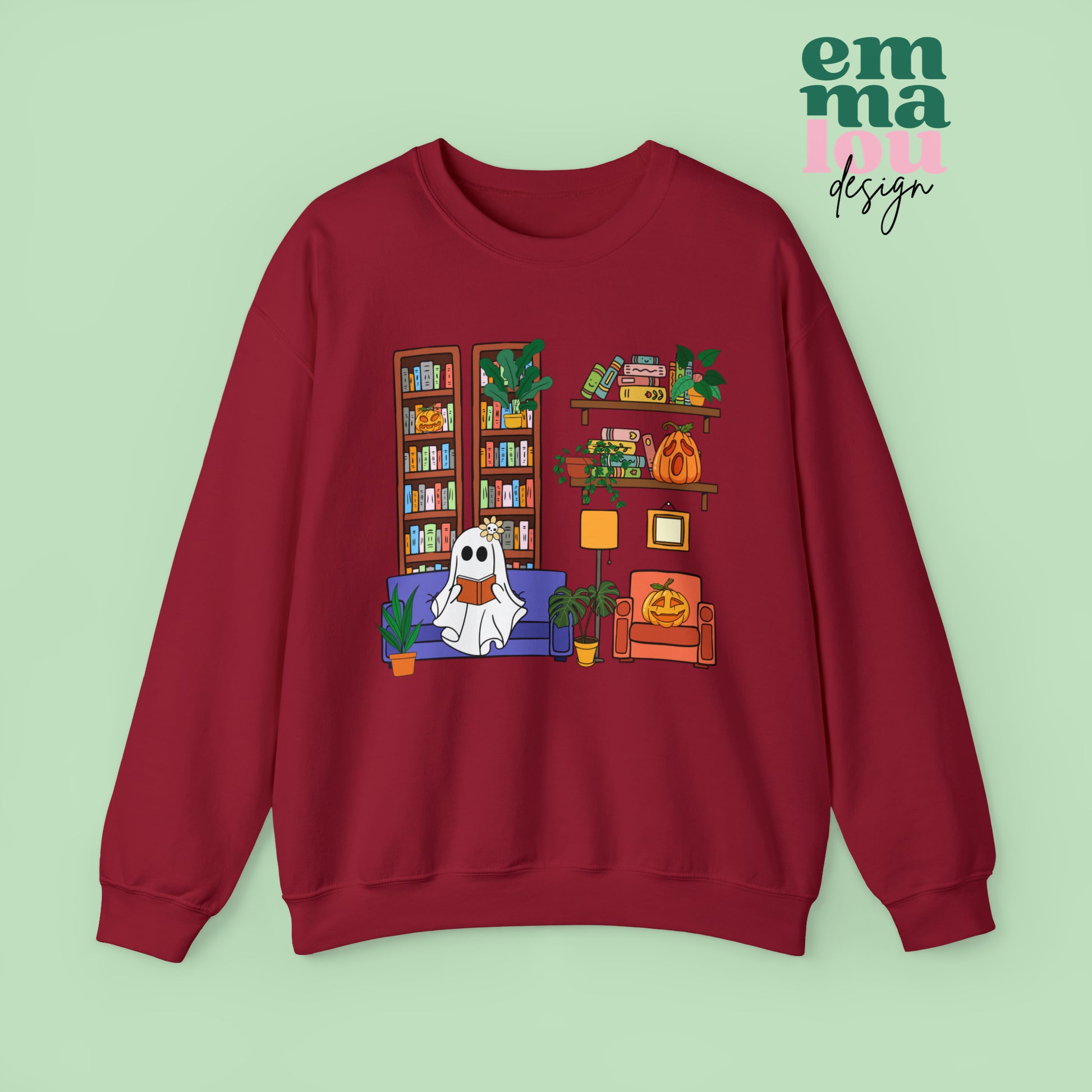 Red  Gildan Crewneck Sweatshirt Featuring a Graphic design featuring a cute ghost with a floral bow reading on a purple couch surrounded by cute house plants and 2 bookcases and shelves with books