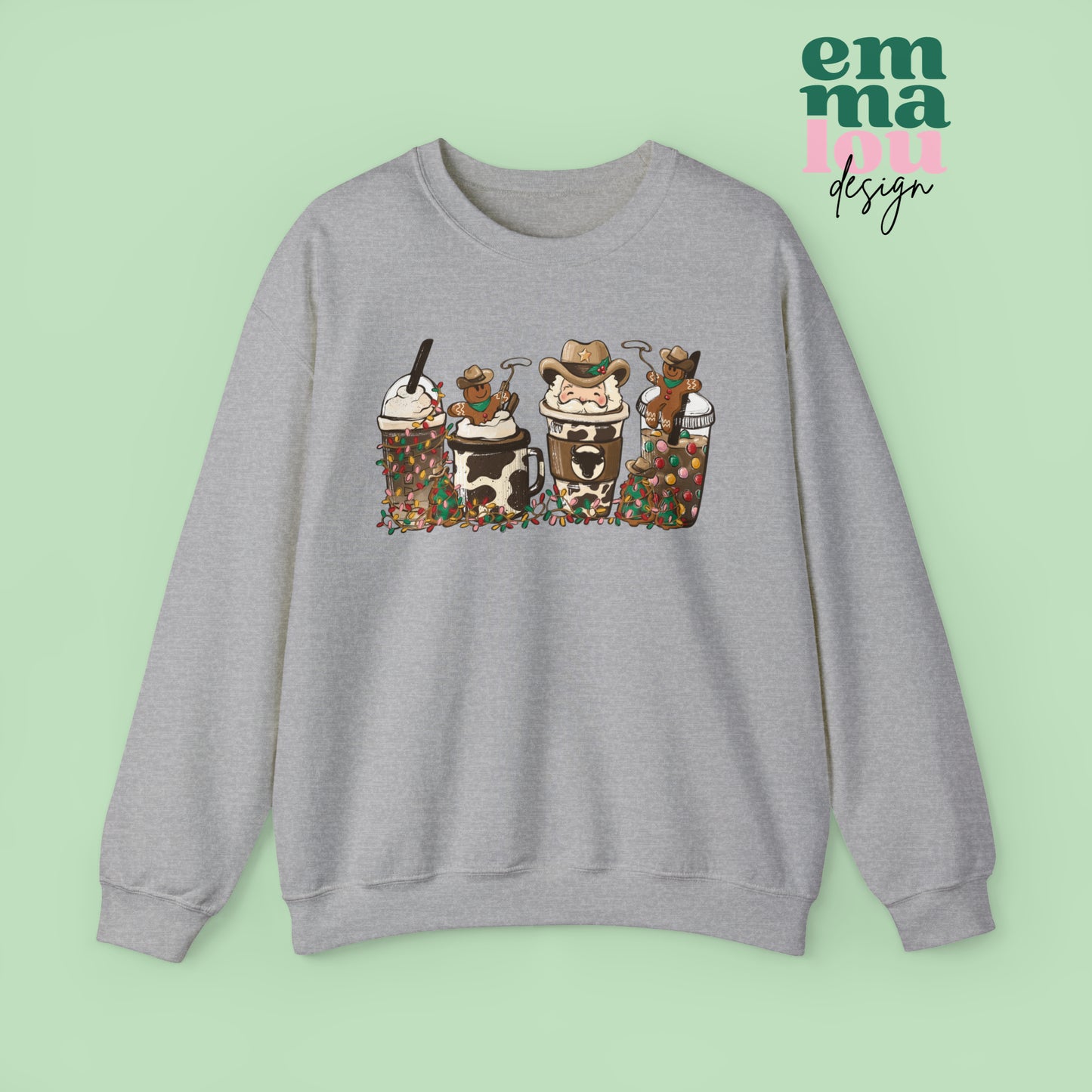 Athletic Grey  Sweatshirt featuring four western christmas coffee lattes. The graphic includes two cowboy gingerbread men and a westner Santa Claus with cow print coffee drins and christmas lights.